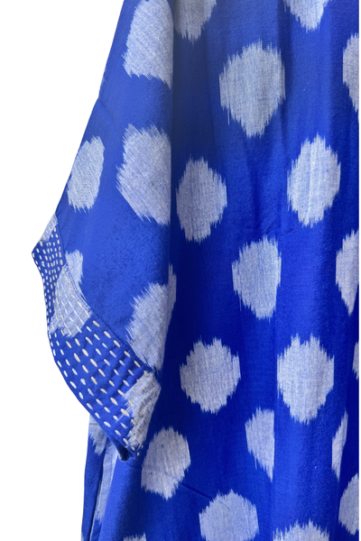 Indigo Blue fabric with grey polka dots with embroidery on the sleeve on a white background