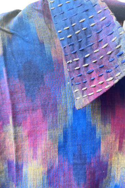 Close-up of a multicoloured Ikat fabric with embroidered details